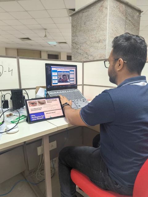 Harsh demoing a project on a laptop at Ignition Hack